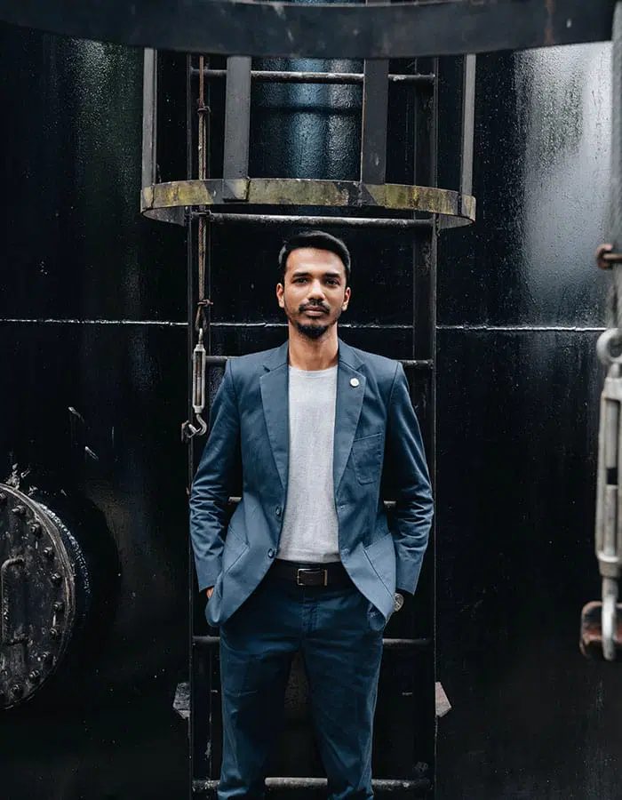 Vinesh Sinha in front of a storage tank ladder